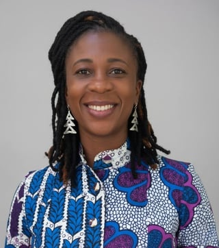 Professional portrait of Constance Owusu with braided hair wearing geometric patterned clothing