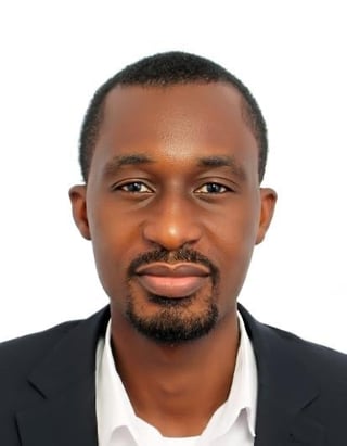 Professional headshot of Ernest James Arthur with short dark hair and facial hair wearing black blazer